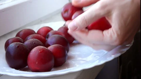 Taking Red Plums Stock Footage 65446691