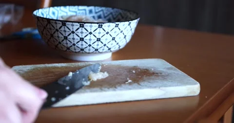 Taking the remains of cut raw meat with a knife from a wooden board and putti Stock Footage 150206279