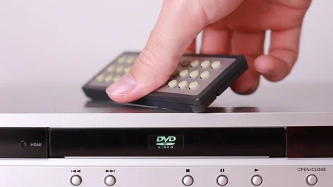 Taking remote control from DVD player and putting it back Vídeo Stock 88245114