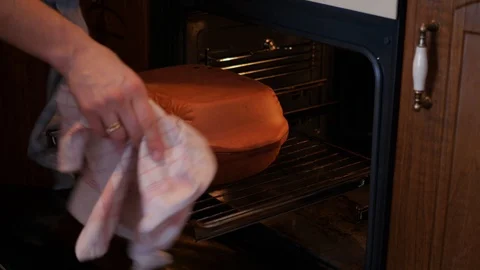 Taking, removing roman clay pot from oven Stock-Footage 87219702