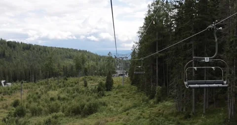 Taking a ride on mountin cableway in beAutiful nature summer. Wedding couple sit Stock Footage 249695791