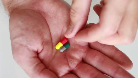 Taking a right pill from a palm Vídeo Stock 79589872