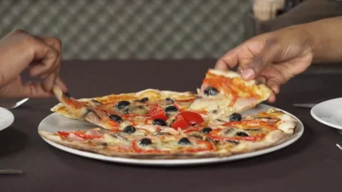 Taking salami pizza slice via spatula. A hot melted cheese is stretching, 库存影片 336586692