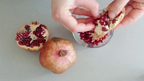 Taking seeds from pomegranate Stock Footage 73015221