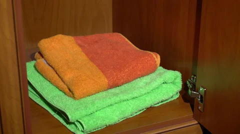 Taking a set of towels from a wardrobe Stock Footage 62083111