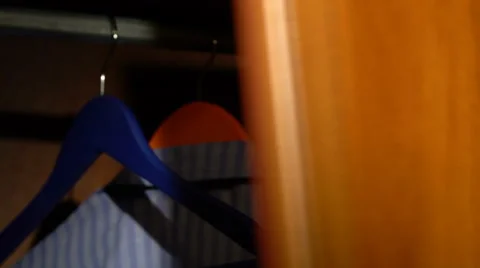 Taking a shirt from a wardrobe Stock Footage 61440374