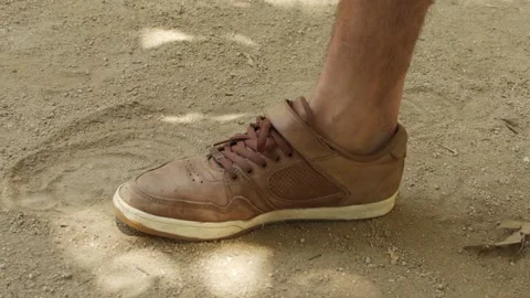 Taking off shoe in the dirt Stock Footage 171175648