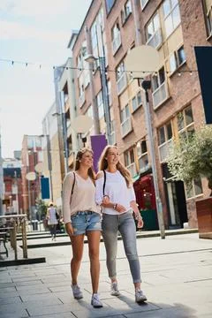 Taking in the sights. Low angle shot of two attractive young girlfriends Photos