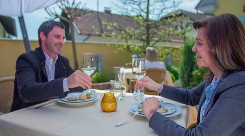 Taking a sip of white wine after a starter Stock Footage 63925633