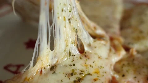 Taking slice of pizza with super stretching stretchy cheese Video stock 137693144