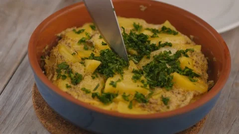Taking a slice of Spanish tortilla Stock Footage 73070696