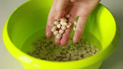 Taking soaked haricot from a pan Stock Footage 73505409