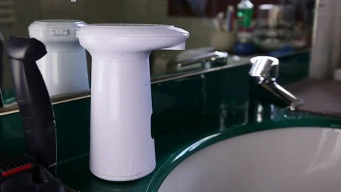 Taking soap from electronic no touch container and washing hands Stock Footage 127519308