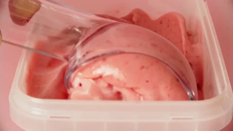 Taking some icecream with spoon from a can of frozen gelato Stock Footage 156881656