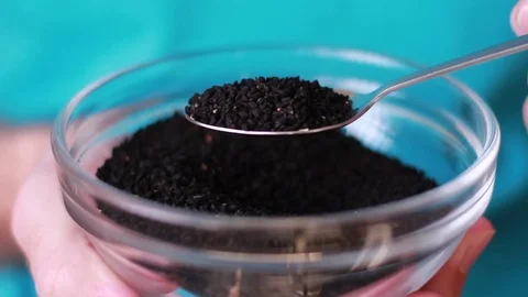 Taking a spoon with black cumin seeds Stock Footage 80799544