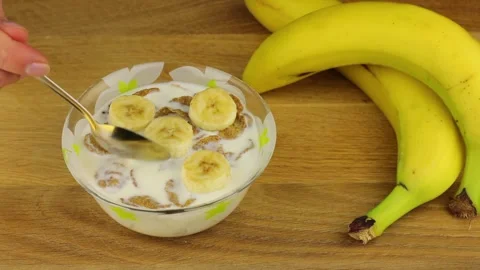 Taking a spoon of flakes whole grain cereals with milk and banana fruit. Stock-Footage 151415547