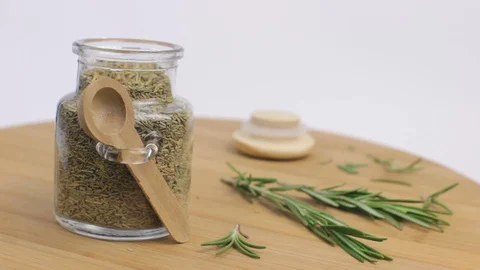 Taking a Spoon of Rosemary for Cooking Stock Footage 88408809