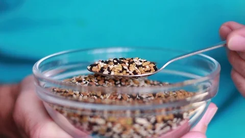 Taking a spoon with spice seeds Stock Footage 80799557