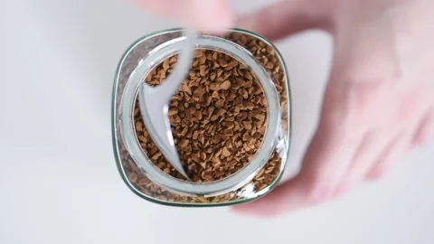 Taking a spoonful from a jar with instant coffee Stock Footage 130846220