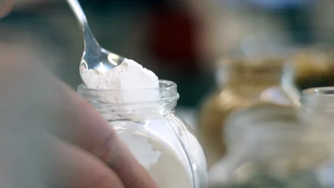 Taking a spoonful of yeast from a jar. Stock Footage 89538827