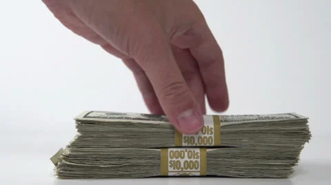 Taking stacks of bills from pile on white Stock Footage 26506230