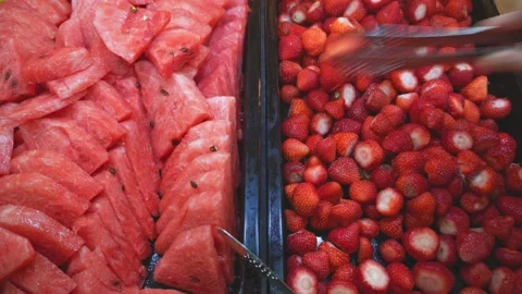 Taking strawberry and watermelon from an open buffet Stock Footage 224315875
