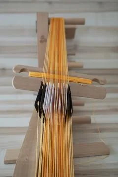 Taking off a stretched web pattern for board weaving Stock Photos