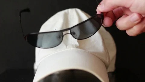 Taking sunglasses from the white cap 動画素材 77178234