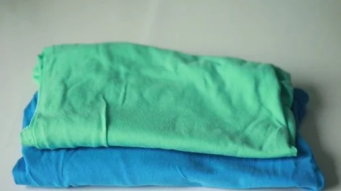 Taking t-shirts from a pile Stock-Footage 73506372