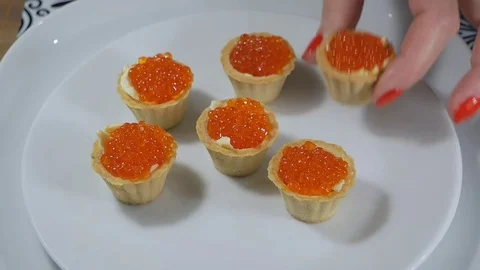 Taking a tartlet snack with red caviar and butter Stock Footage 84852967
