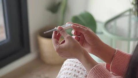 Taking temperature with a thermometer at home Stock Footage 343708963