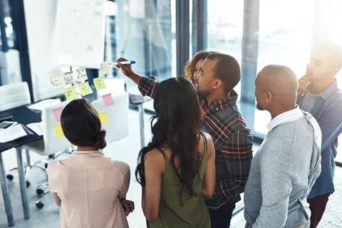 Taking them through the gameplan. High angle shot of a group of coworkers Stock Photos