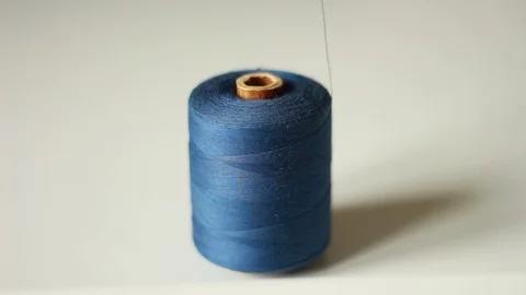 Taking thread from a blue thread coil 스톡 동영상 76039348