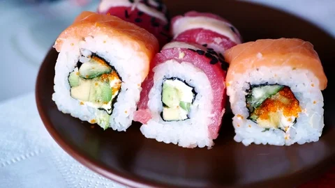 Taking three sushi rolls from plate. Stock Footage 70674486