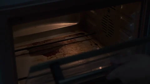 Taking toast bread out of an oven Stock Footage 137431442