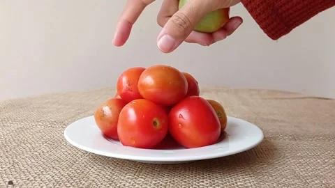 Taking the top tomato on a tomatoes pyramid Stock Footage 149957644