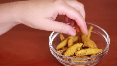 Taking turmeric root from the plate 스톡 동영상 81057539
