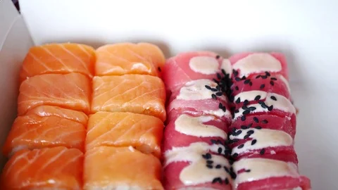 Taking two sushi rolls from delivery box. Stock Footage 70674742