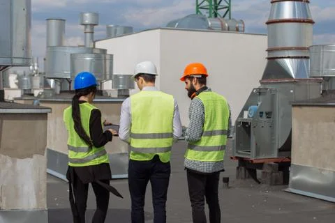 Taking video from the back rooftop of construction site one architect and two Stock Photos