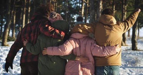 Taking video from the back of a young group of friends walking through the hard Stock Footage 111824634