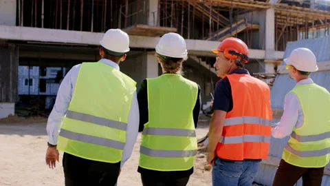 Taking video form the back of a group of diverse young specialists and foreman Stock Footage 146600998