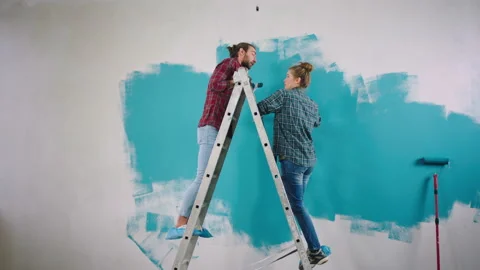 Taking video large couple good looking standing high on the scale to painting Stock Footage 171227577