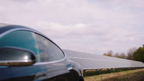 Taking video large of a electric car and photovoltaic batteries in the green Stock Footage 163977914