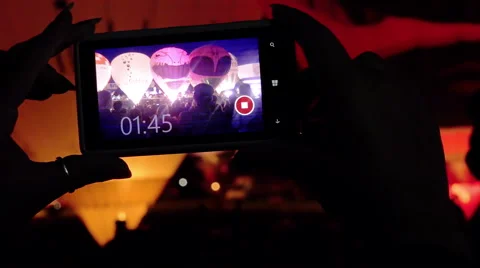 Taking video with smartphone during 2015 Bristol Balloon Fiesta - night show Stock Footage 55406739