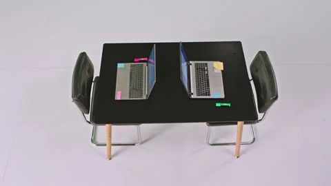Taking video from the top in the white large studio one office table two laptops Stock Footage 131563268