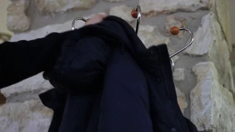 Taking a warm jacket from a rack Stock Footage 71952416