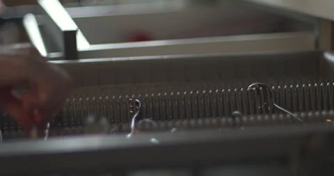 Taking washed silverware from dishwasher rack 5.7K video Stock Footage 301767290