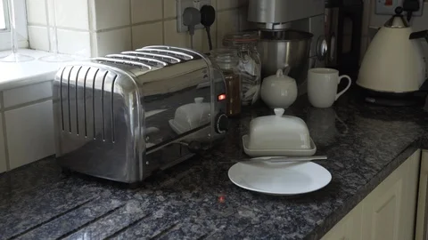 Taking white bread Out of Toaster and spreading big slab of butter Stock Footage 111708129