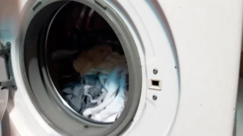 Taking white clothes in the washing machine. Stock Footage 221460647