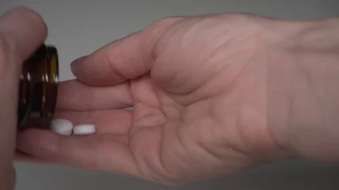 Taking white pills from the jar Stock Footage 101588683